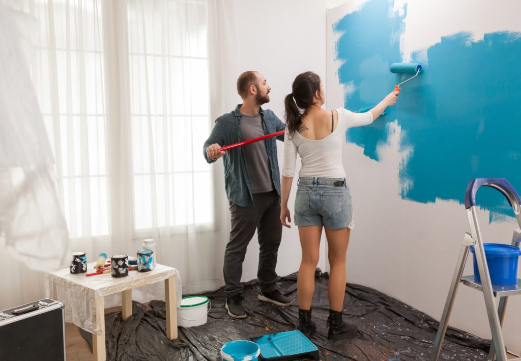 Painting wall using roller paint brush